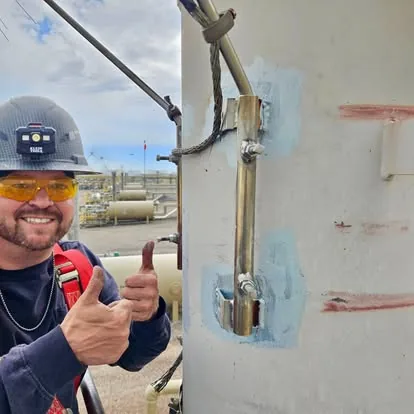 Jake Zink beside a completed welded field repair