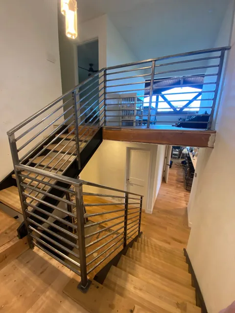 Interior steel stair railing spanning two levels