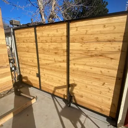 Completed wood and black steel sliding gate