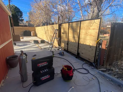 Large wood and steel sliding gate during installation